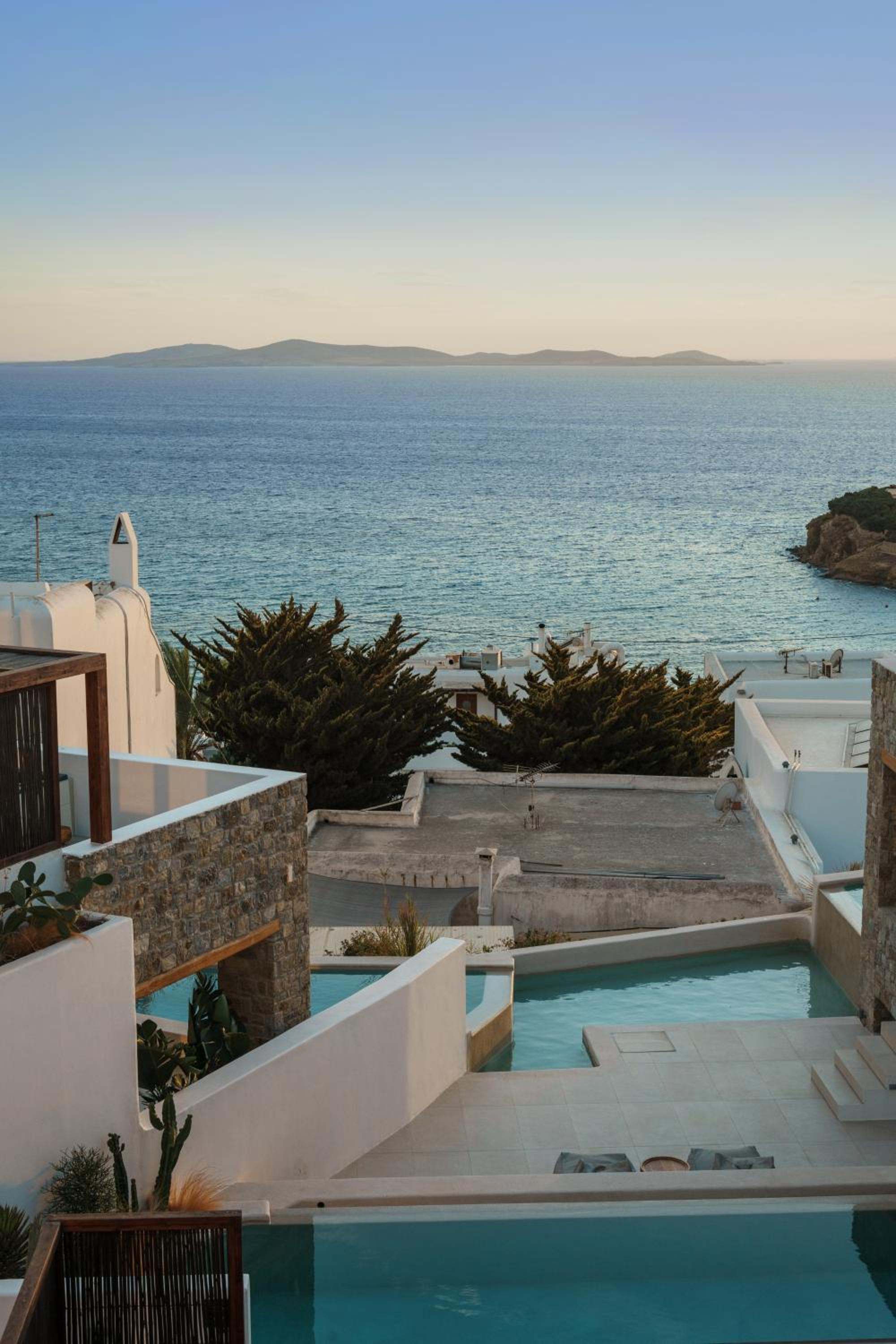 Terraces and pools of Bard De Sol stepping down towards the sea at Agios Stefanos
