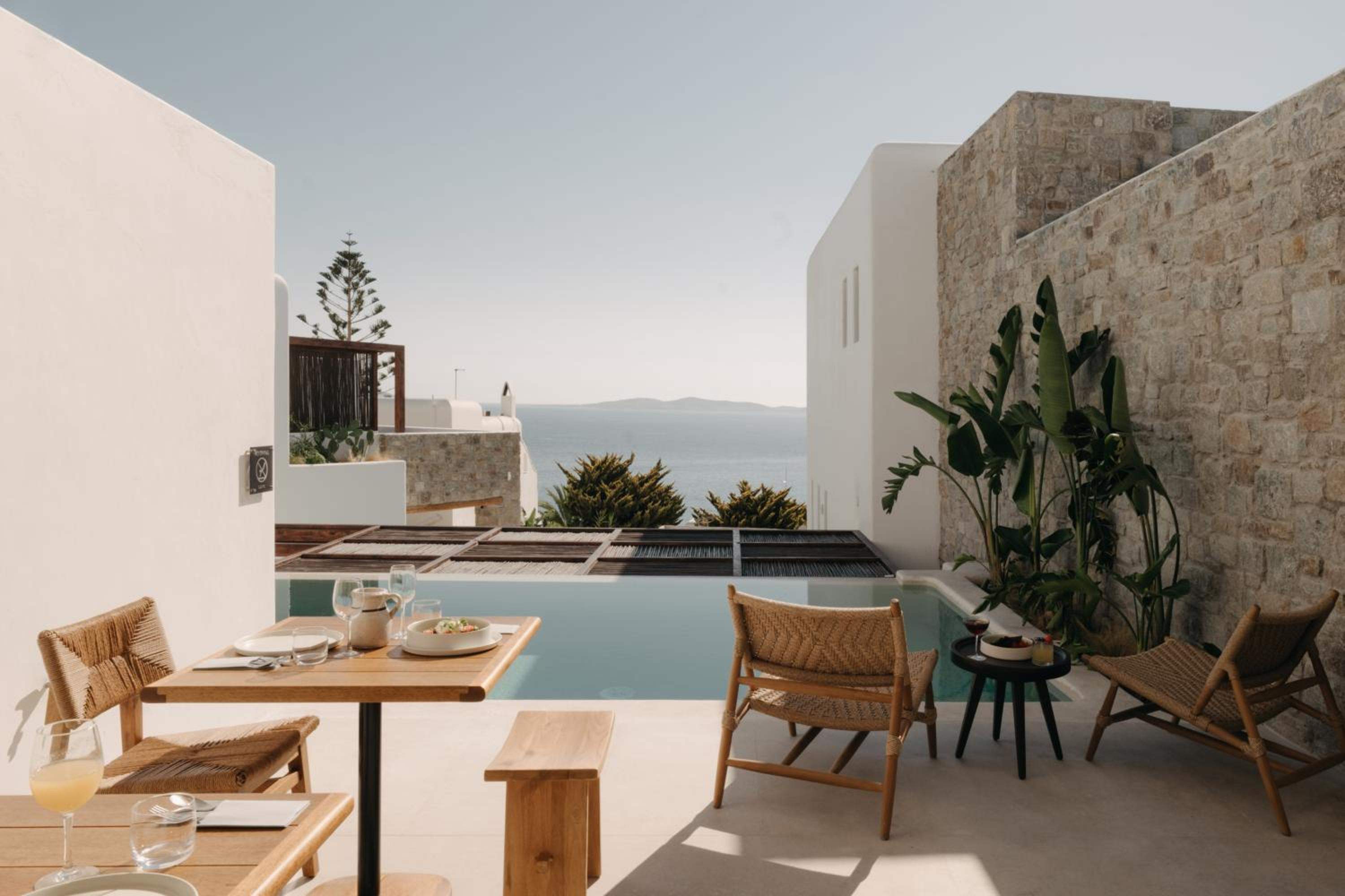 Breakfast laid out on a poolside terrace overlooking the sea