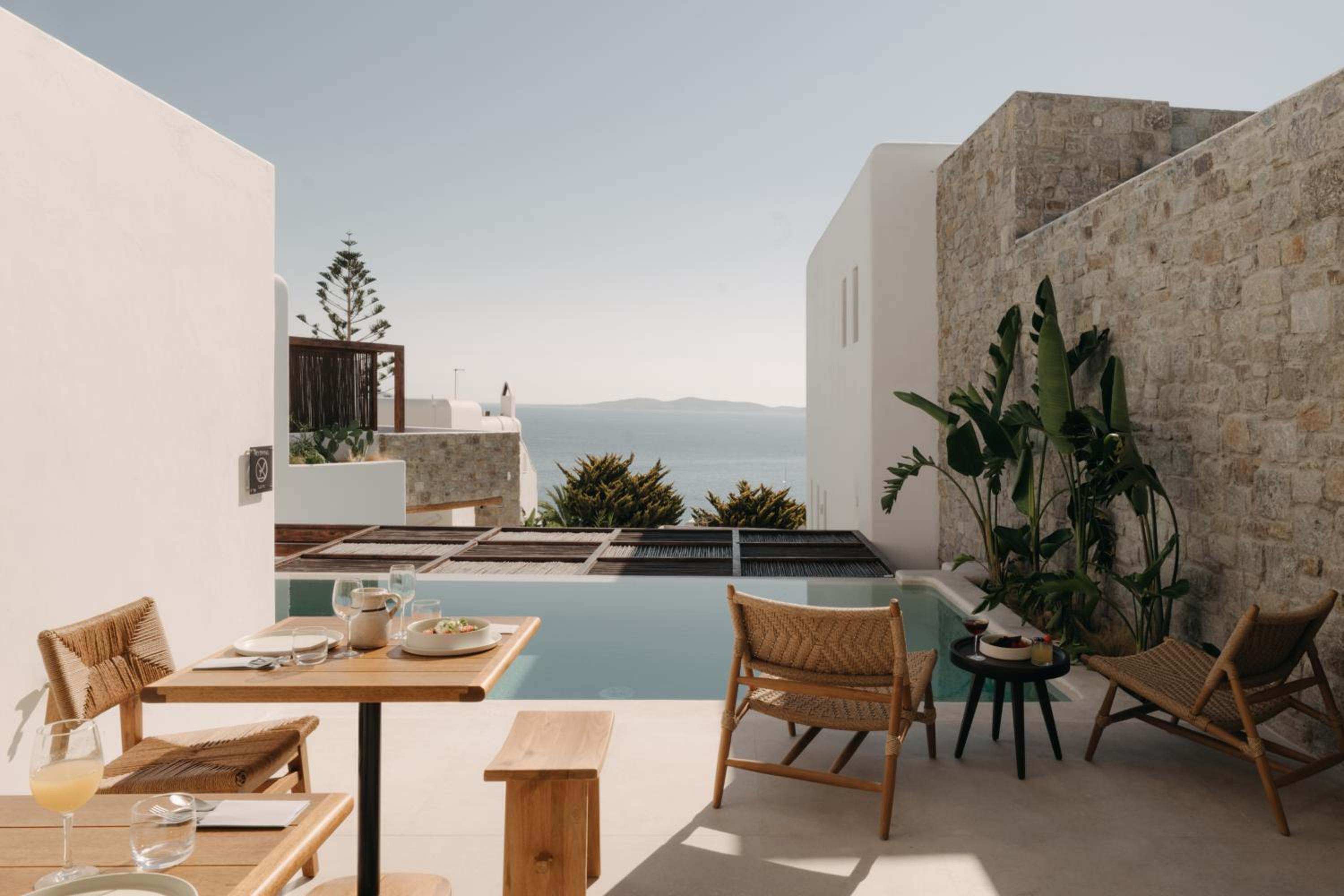 Breakfast laid out on a poolside terrace overlooking the sea