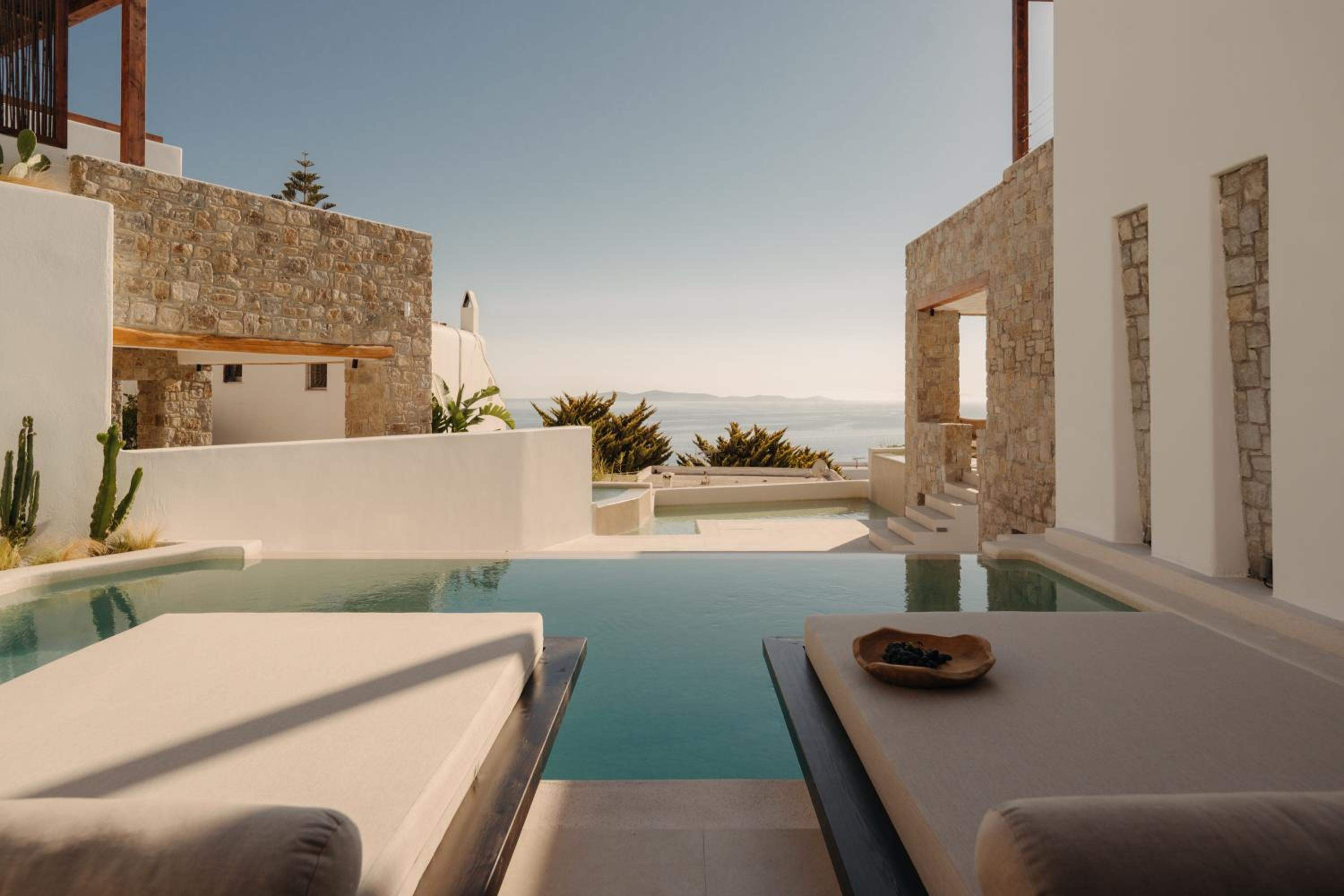 Del Sol Suite: daybeds beside the private pool, with the sea beyond