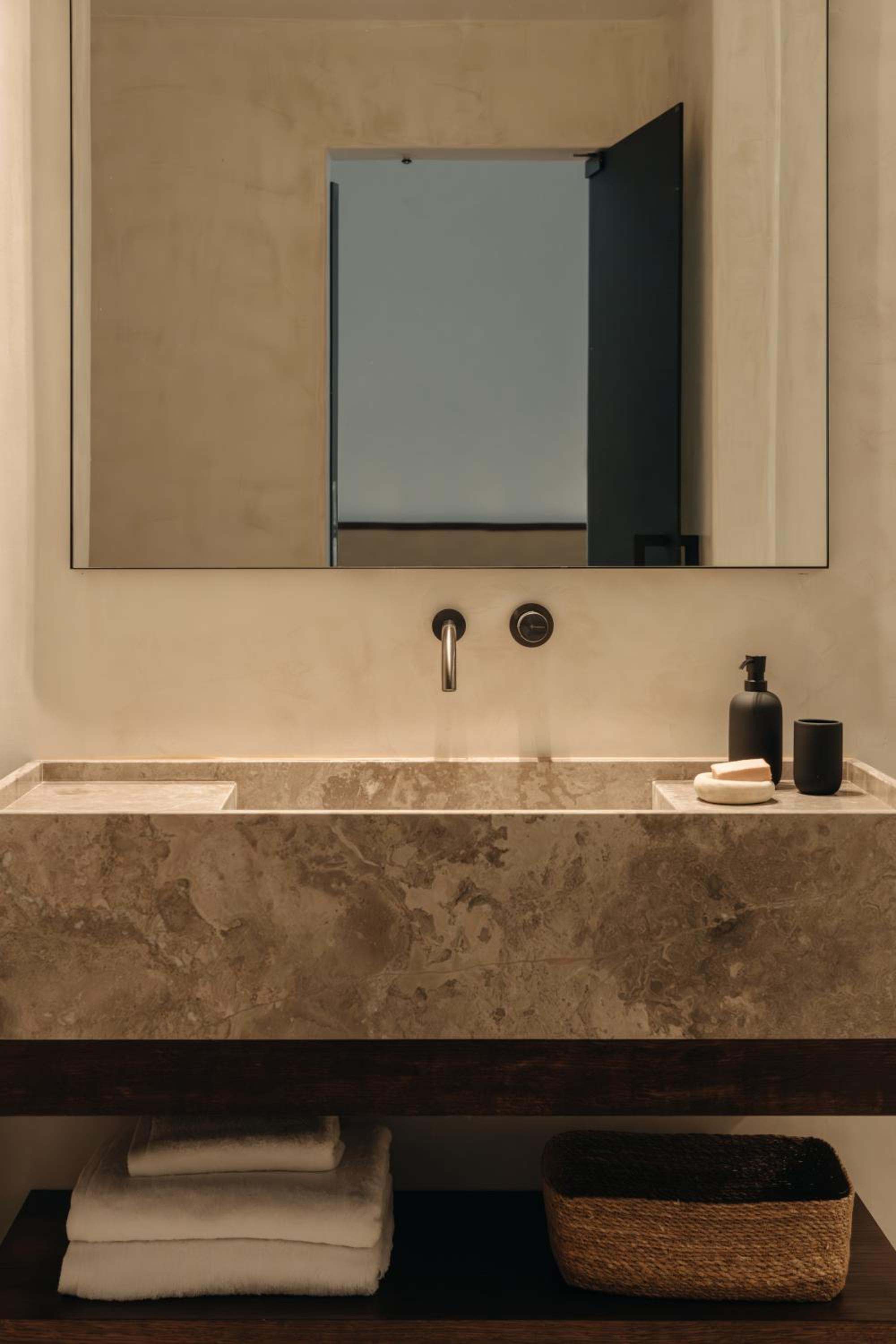 Del Sol Suite: a stone washbasin beneath a mirror