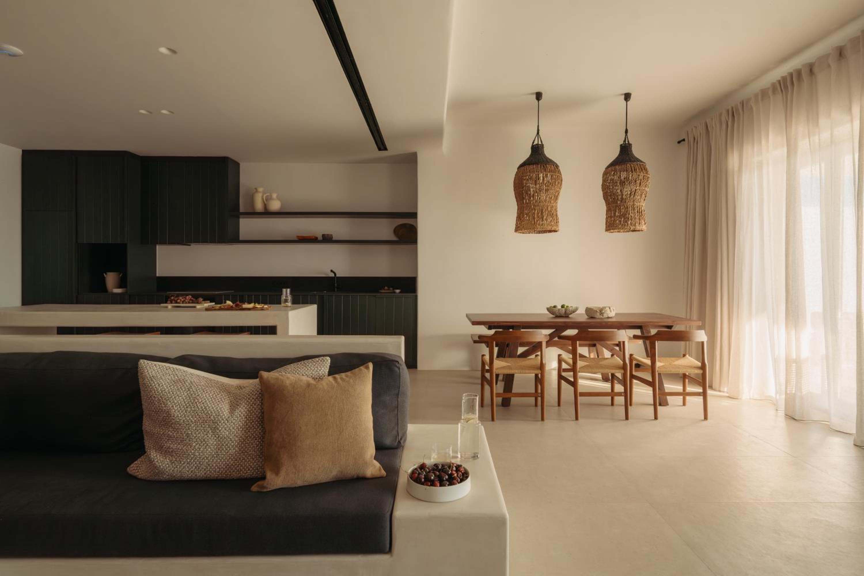 Premier Suite: the living area with kitchen, dining table and full-height curtains