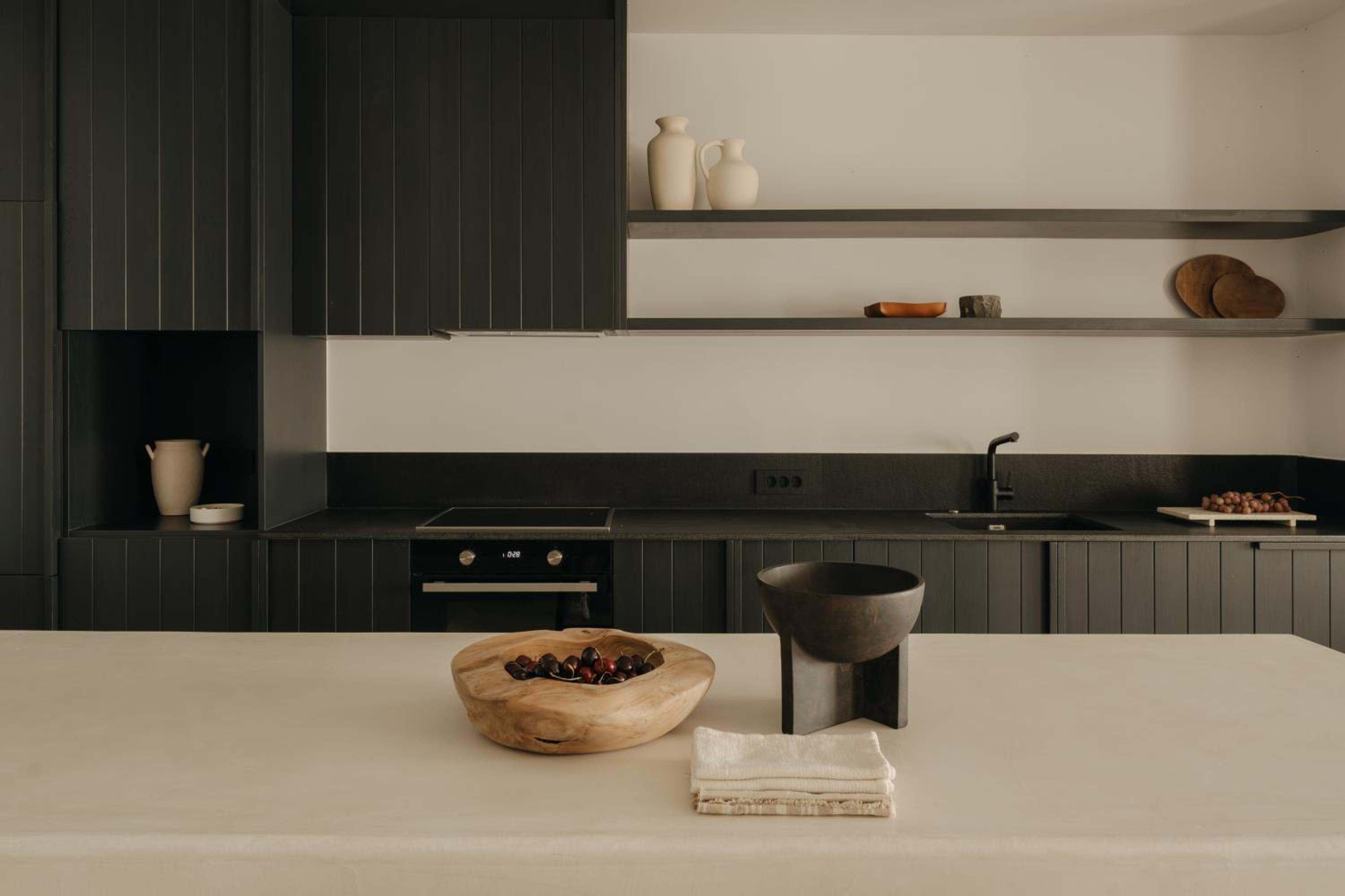 Premier Suite: the kitchen, with dark cabinetry and open shelving