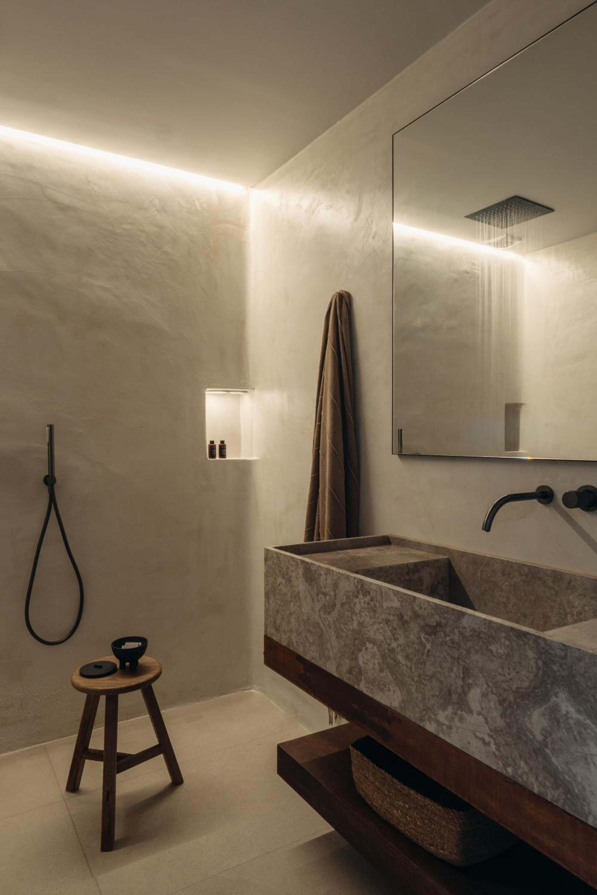 Premier Suite: the bathroom, with a stone basin, mirror and walk-in shower