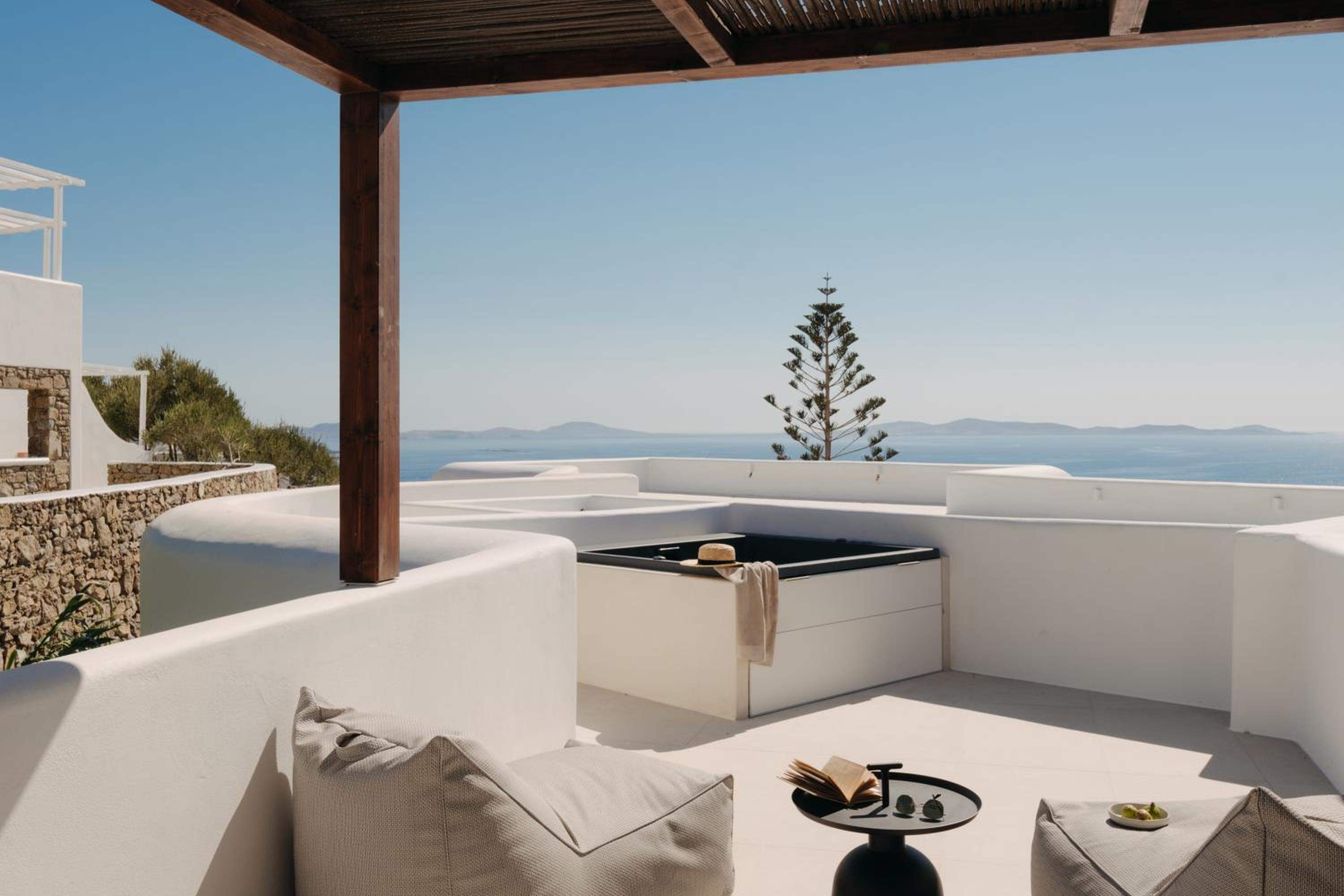 Junior Suite with Outdoor Hot Tub: the terrace hot tub under a timber pergola, with the sea beyond