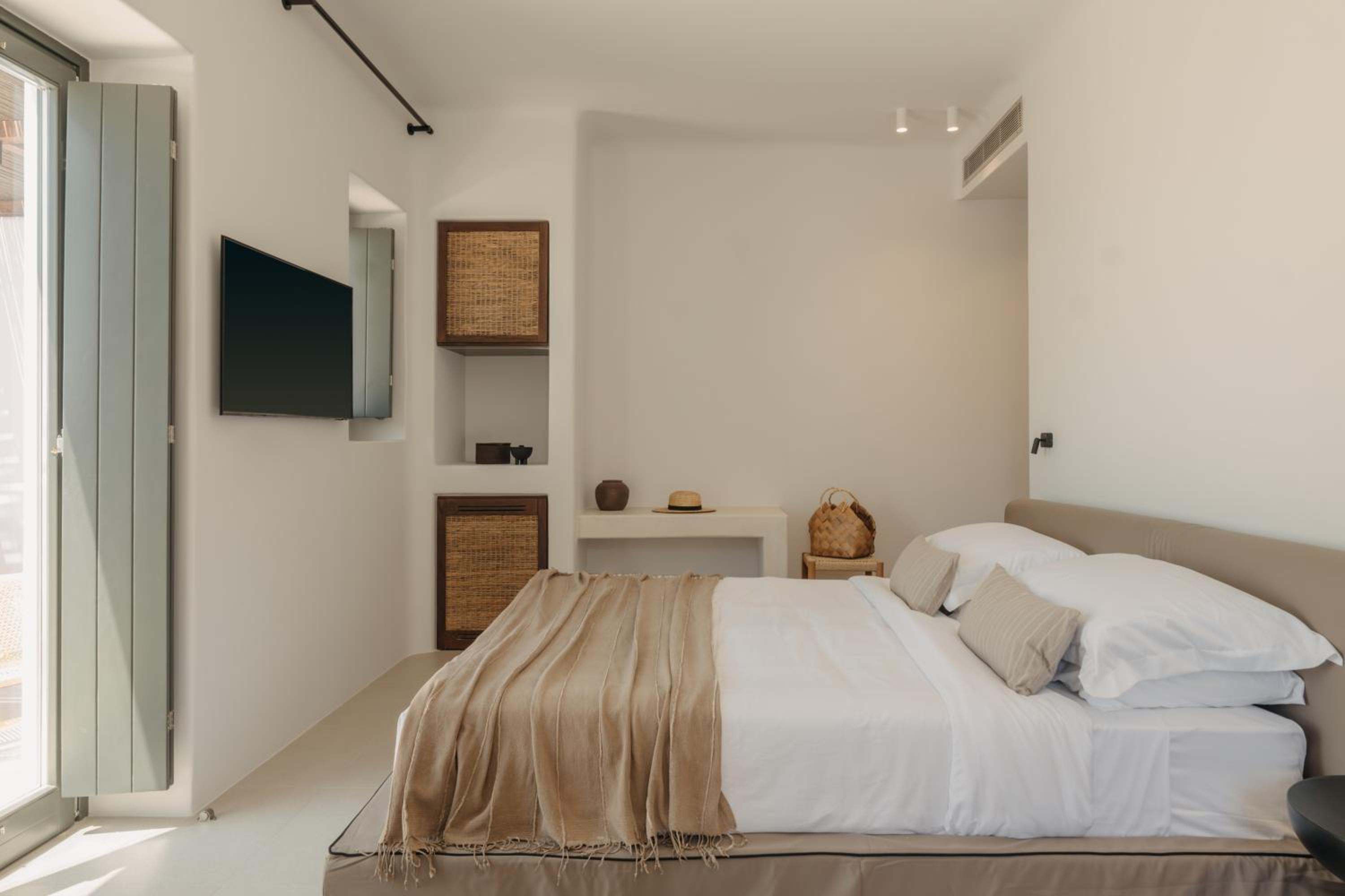 Junior Suite with Outdoor Hot Tub: a double bed with linen throws