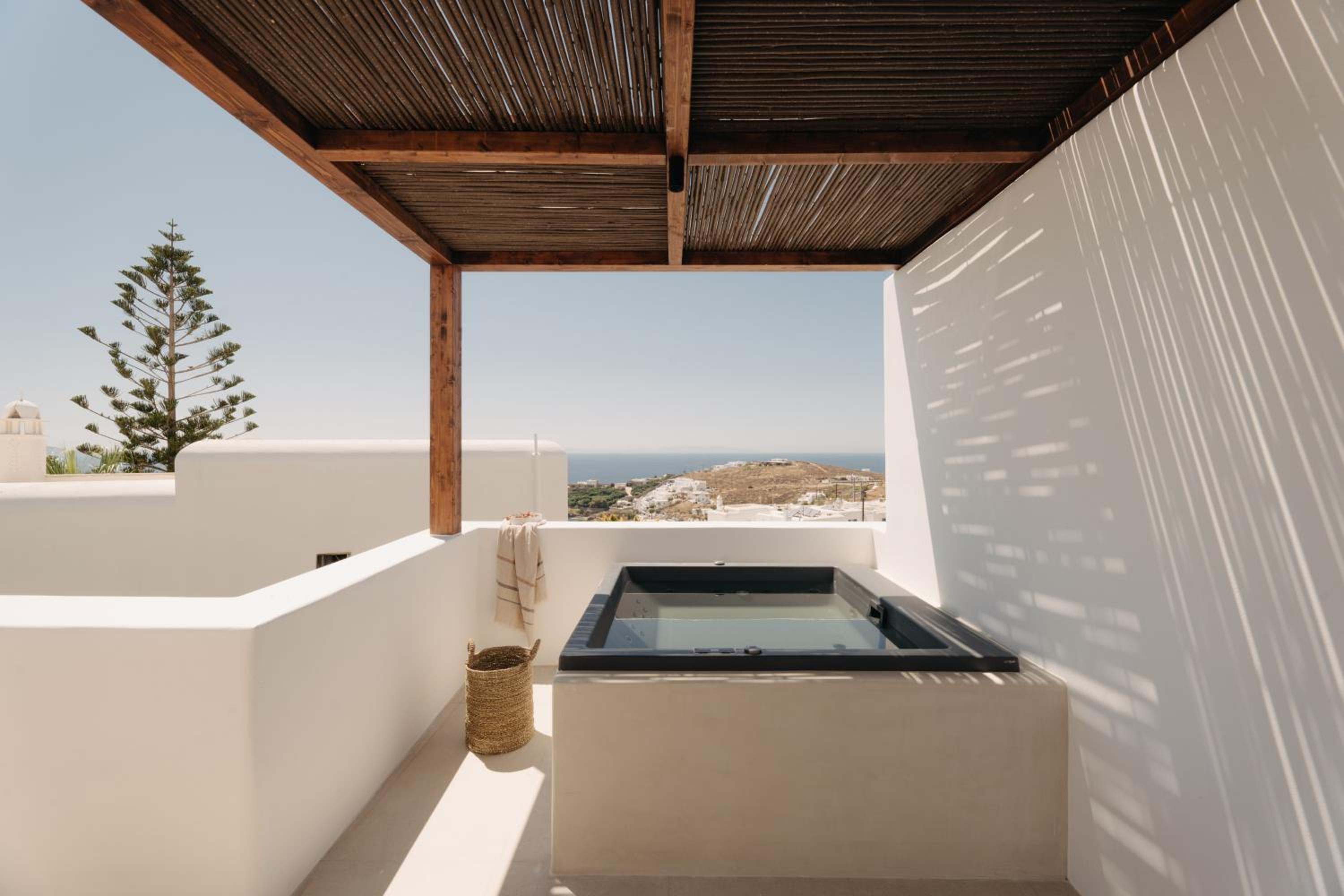 Junior Suite with Outdoor Hot Tub: the outdoor hot tub on a whitewashed terrace
