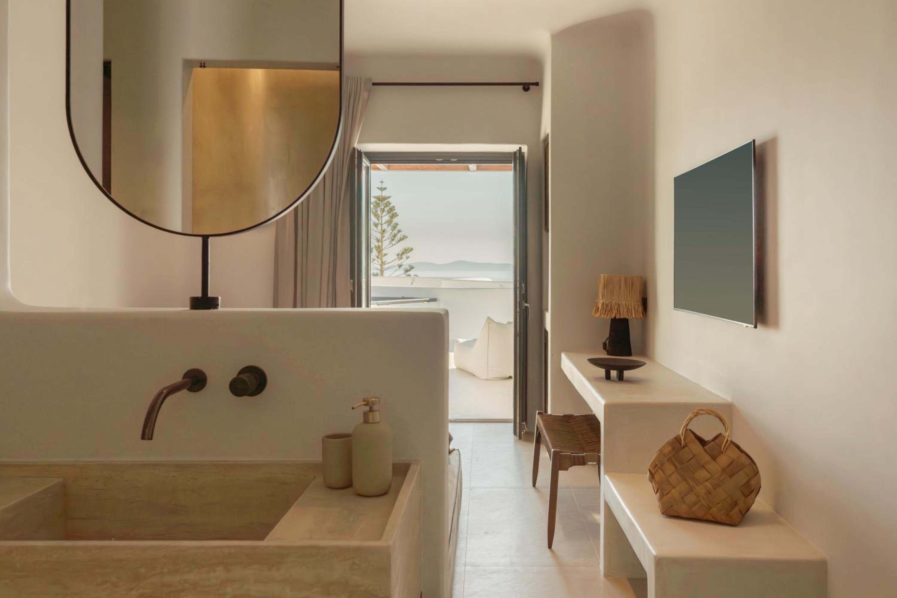 Junior Suite with Outdoor Hot Tub: a stone basin, with the terrace visible through the open door