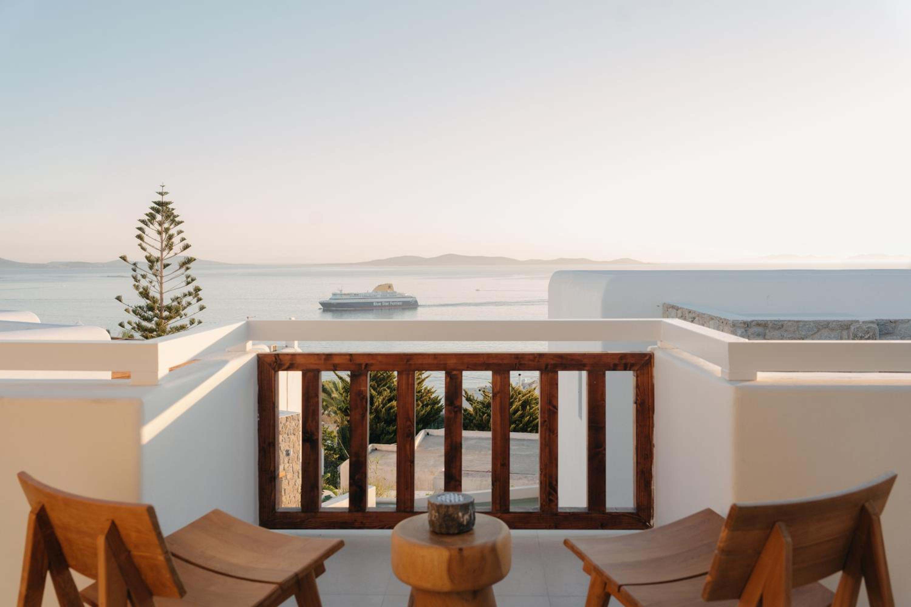 Junior Suite with Outdoor Hot Tub: two chairs on the balcony, with the sea beyond