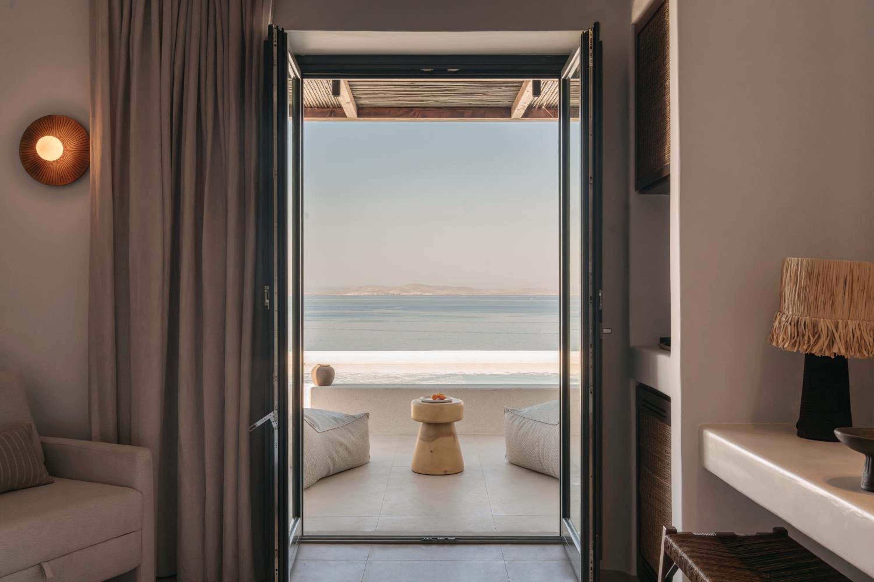 Junior Suite with Private Pool: open doors from the room onto the pool terrace and the sea