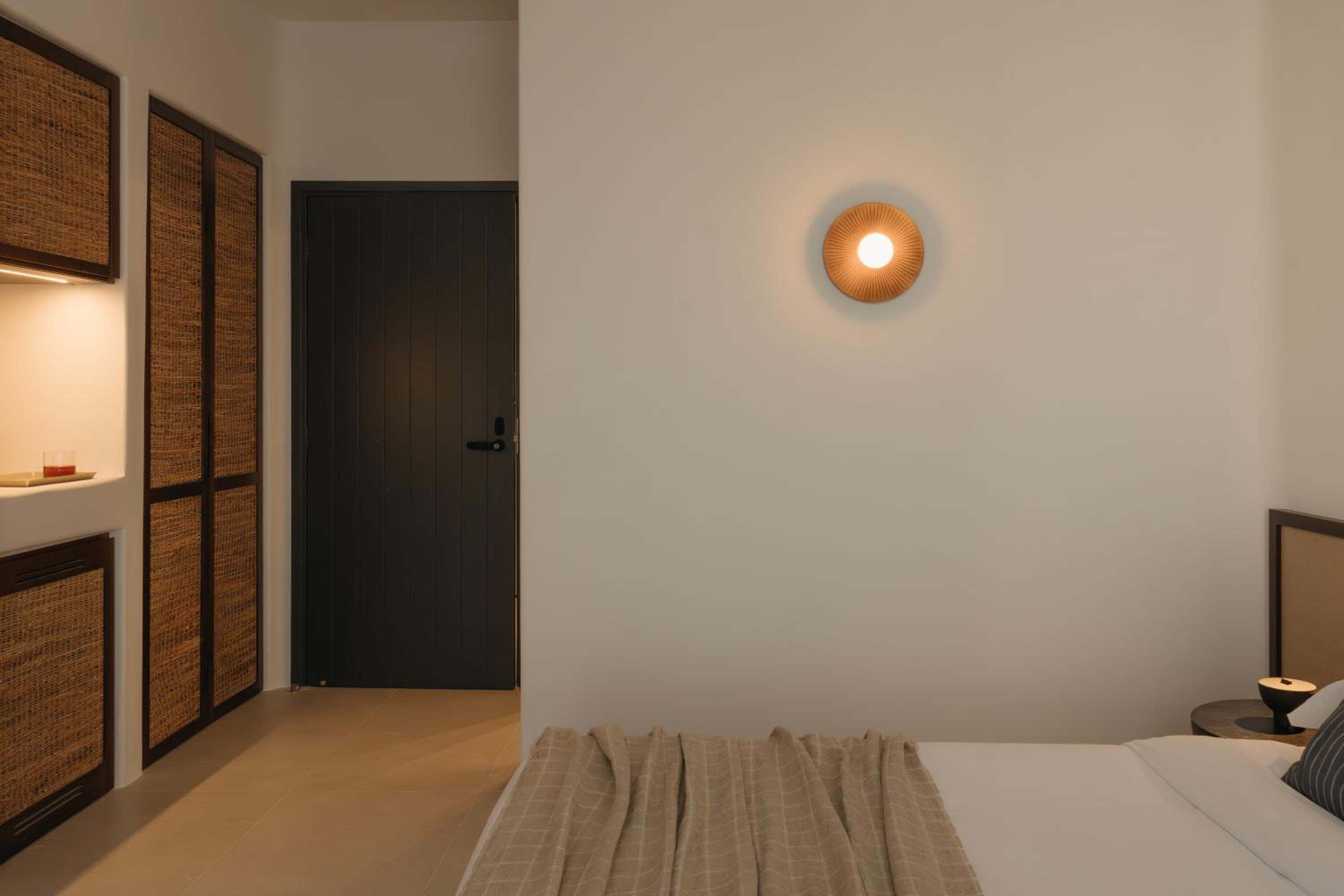 Deluxe Room: a woven wardrobe and the room door