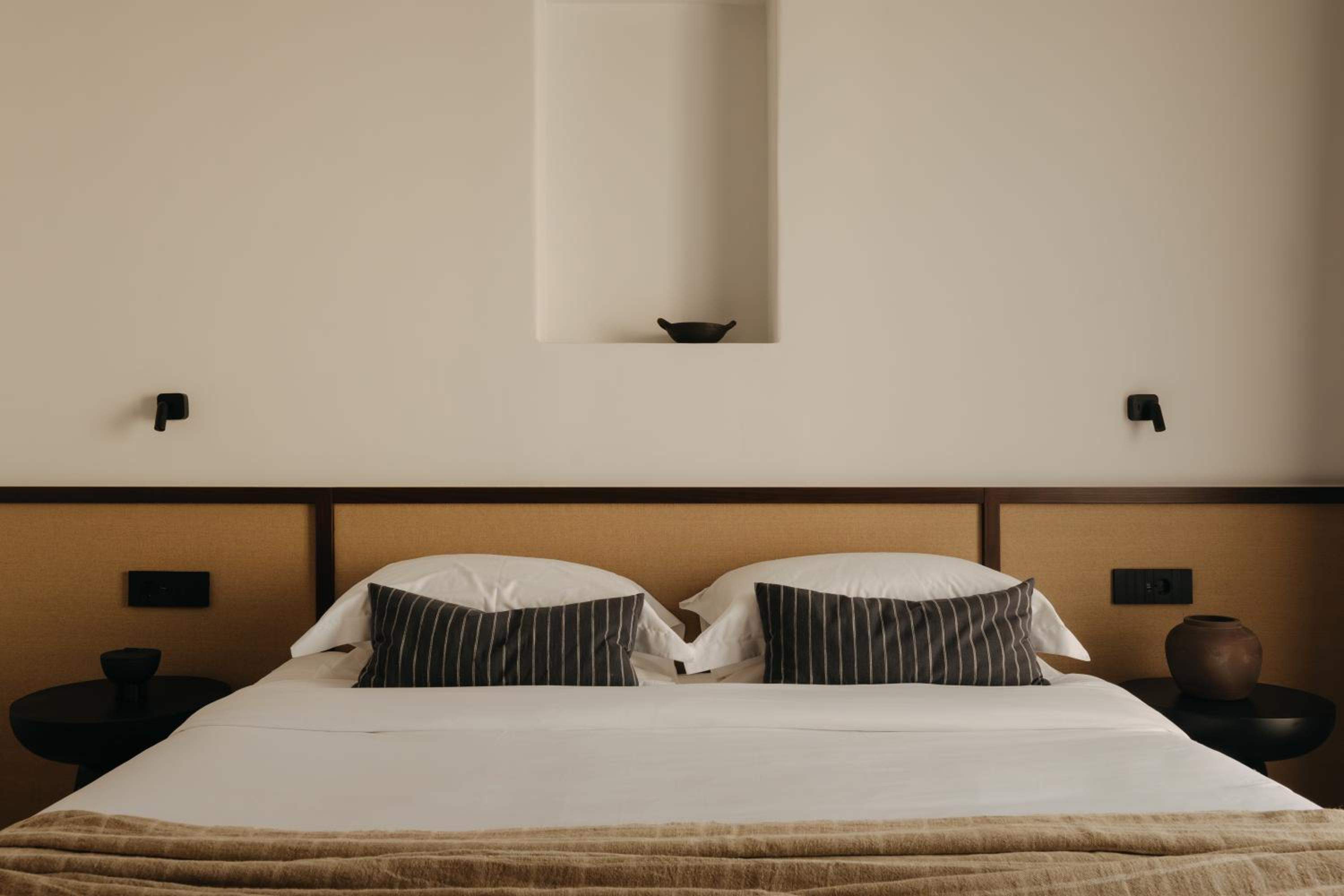 Superior Room: a double bed with a woven headboard
